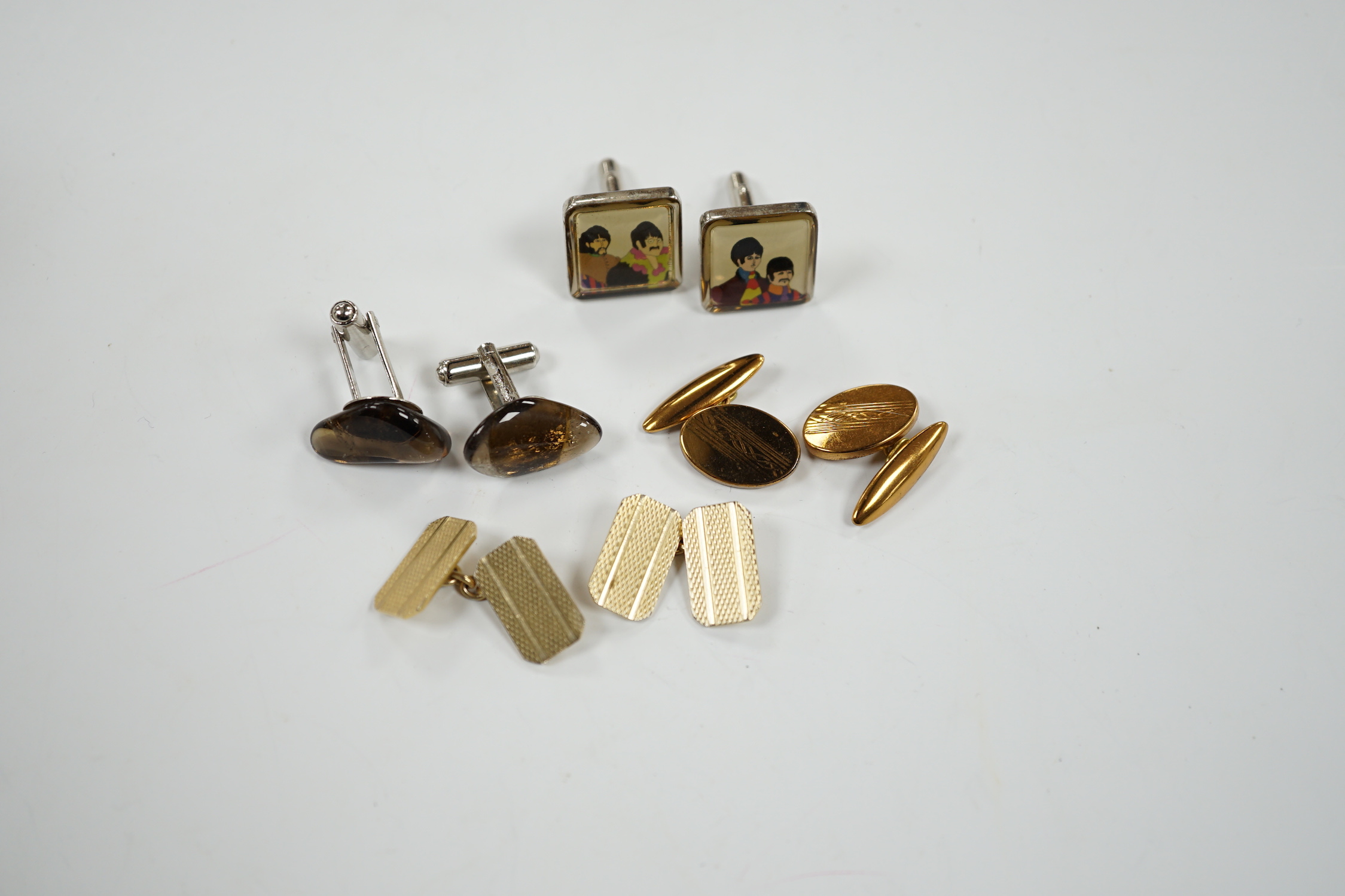 Four assorted pairs of gilt or base metal cufflinks including 'The Beatles'.